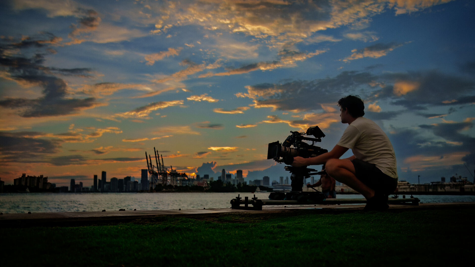 Cinematographer silhouetted at sunset, Miami waterfront